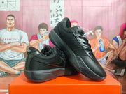 Black Nike basketball sneakers displayed at an angle, showing the side logos, lace-up construction, and rubber tread.