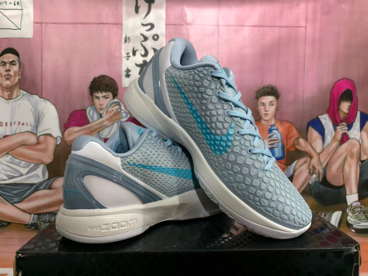 Pair of grey and blue Nike basketball shoes shown from the side