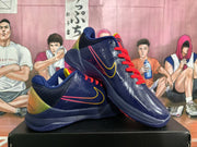 Angled view showing the pair of navy basketball sneakers, red laces, perforated side panels, and layered outsole.