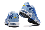 Rear and outsole views of blue Nike Air Max Plus sneakers with white midsoles.