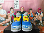 Front view of blue Jordan 3 sneakers with yellow laces