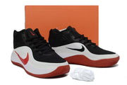 Black, white, and red Nike basketball sneakers displayed in front of an orange shoe box.