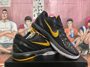 Pair of black and yellow basketball sneakers shown at an angle, with textured uppers, yellow Nike Swooshes, and white outsoles.