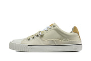 Side profile of a cream low-top sneaker with a tan heel tab and textured panels.