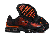Nike sneaker side and outsole view showing orange outsole accents.