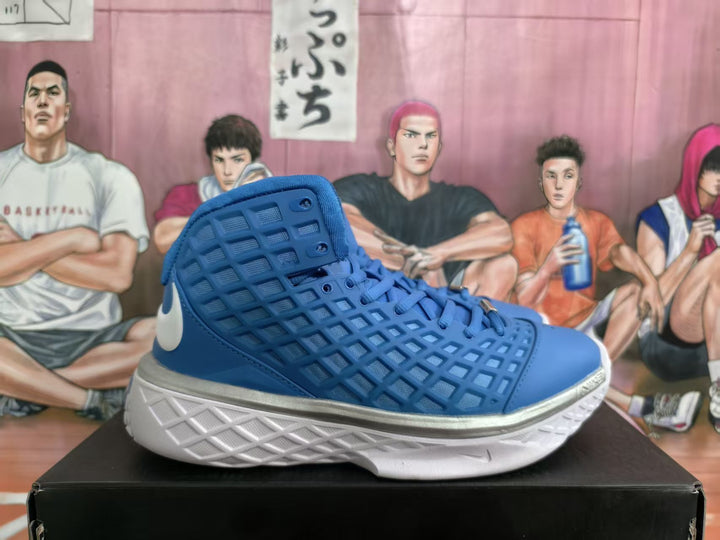 Blue Nike high-top basketball sneaker shown in side profile with a white Swoosh, textured white outsole and metallic silver midsole accent.