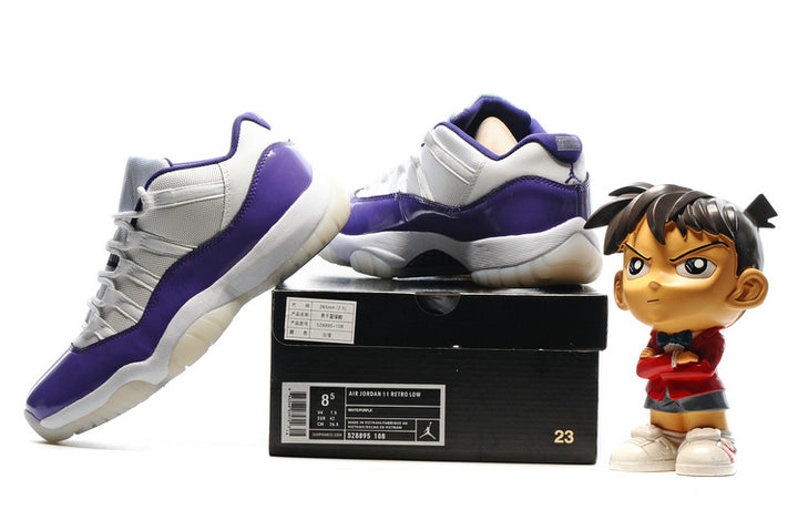 Pair of purple and white low-top sneakers displayed on a black shoebox, with one shoe resting on top.