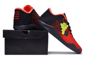 Red and black basketball sneaker posed on a black shoebox, showing the heel and side details.
