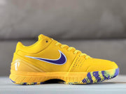 Side profile showing the yellow upper, perforated toe panel, purple side detailing, and patterned outsole.