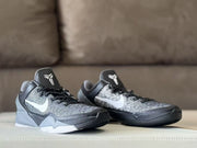 Front three-quarter view of the Nike Kobe 7 sneaker pair with black laces and contrasting grey panels.