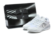 White and silver basketball shoes displayed beside a black shoe box