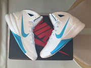 Overhead angled view of the pair highlighting the high-top shape, side Swooshes, and blue outsole sections.