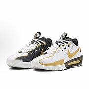 Pair of Nike basketball sneakers in black, white, and gold with contrasting midsoles.