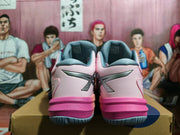 Rear view of the pink and gray shoes, showing the heel details and contrasting midsoles.