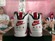 Rear view showing red pull tabs, visible Nike branding, and AIR lettering on the white heels.