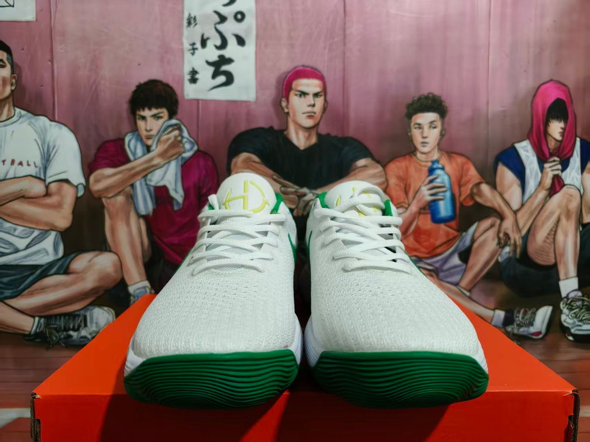 Front view of white Nike sneakers with green accents