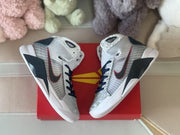 Overhead view of a pair of high-top shoes resting on a red box
