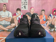Pair of black lace-up running shoes shown from the front.