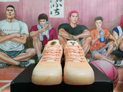 Front view of the pair showing the rounded toe boxes, pink laces, and light peach-pink upper.