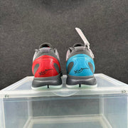 Rear view of a mismatched Nike sneaker pair with red and blue heel accents, dark uppers and white outsoles.