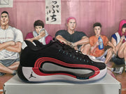 Side profile highlighting the black upper, red layered side detail, gray paneling, white midsole, and visible Jumpman logo.