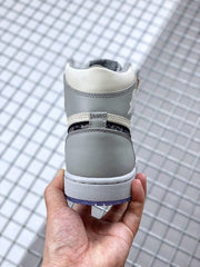 Rear view showing the gray heel panel, white collar, layered stitching, and blue outsole edge.