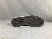 Black rubber outsole shown from below with circular traction grooves and a patterned forefoot.