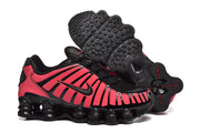 Black and pink sneakers shown from the side and underside, with textured outsole.