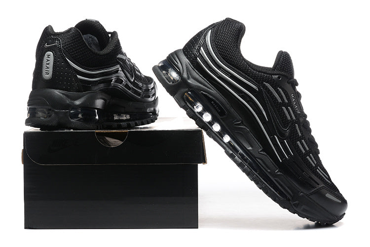 Pair of black sneakers with gray accents and visible sole cushioning, displayed with a black shoebox.