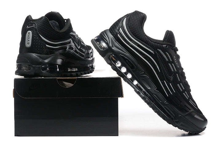 Pair of black sneakers with gray accents and visible sole cushioning, displayed with a black shoebox.