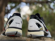 Rear view of the sneakers showing visible KOBE and VI markings on the white heel panels.