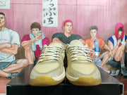 Front view showing the laces and cream-and-olive upper