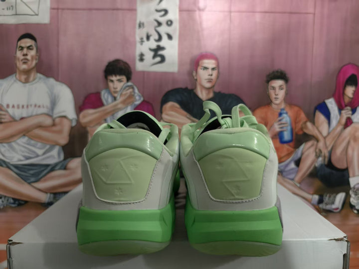 Rear view of mint green Jordan basketball sneakers showing padded heel panels, green outsoles, and a white-gray upper.
