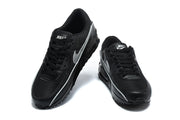 Top and front views of a pair of black Nike Air Max 90 sneakers with silver Swooshes.