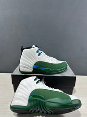 Pair of white and green high-top sneakers displayed on and in front of a black Jordan shoebox.
