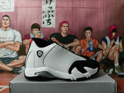 Side profile of one white and black high-top sneaker showing the textured white upper, black toe area, red accent, and layered sole.