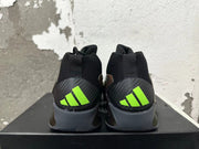 Rear view of black high-top basketball shoes with gray heel panels and bright lime-green Adidas marks.
