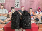 Rear view of black Nike sneakers showing heel pull tabs, layered panels, and sculpted outsoles.