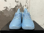 Front view of light blue Nike basketball shoes with textured uppers, matching laces and padded tongues.