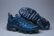 Blue sneaker pair with one shoe tilted to display the outsole pods.