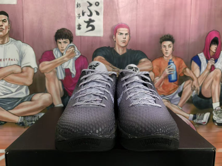 Front view of black and purple Nike basketball sneakers with light-colored laces on a black shoebox.
