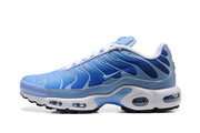Side profile of a blue Nike Air Max Plus sneaker with visible midsole cushioning.