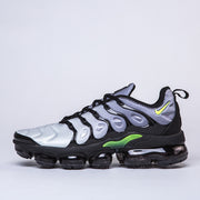 Side profile of a silver-gray, black, and green Nike TN-9 sneaker.