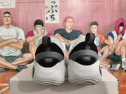 Rear view of white basketball shoes with black heel details and a sculpted sole.