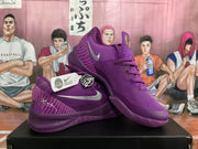 Angled view of the purple Nike basketball sneakers showing the low-cut shape, Swoosh branding, laces, and heel details.