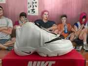 Side view of a white Nike high-top sneaker with black Swoosh details and a sculpted outsole.