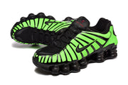 Pair of green-and-black Nike Shox TL sneakers in a three-quarter view.