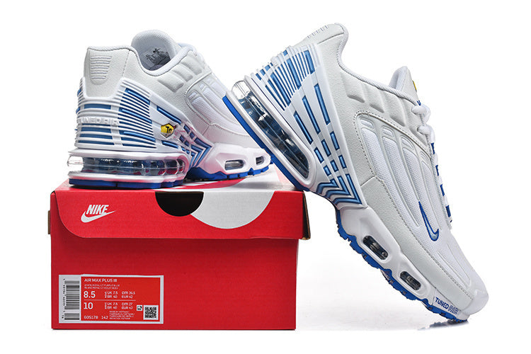 White and blue Nike Air Max Plus III sneakers displayed with a red shoe box labeled Air Max Plus III; the box shows a sample size.