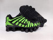 Green-and-black Nike Shox TL sneakers showing the side and outsole.