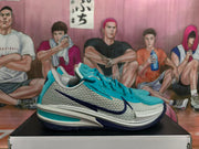 Side view of a Nike GT Cut 3 shoe showing its mesh-look grey panel and navy Swoosh